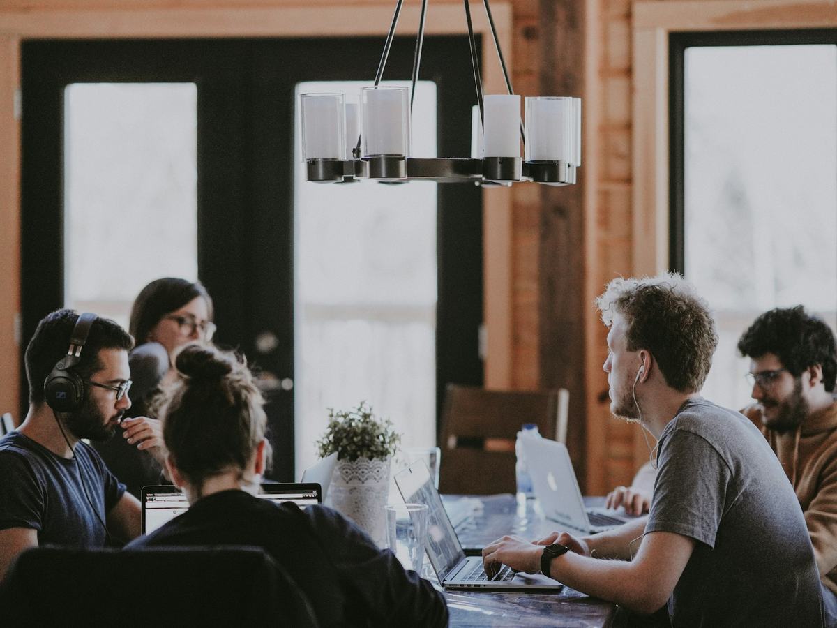 Team of adults working together in a bright office